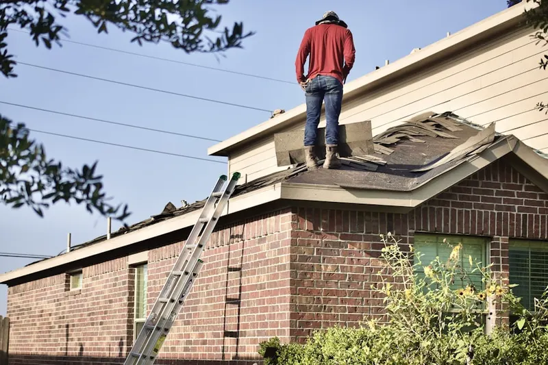 Professional roofer working on a residential roof in Manitowoc